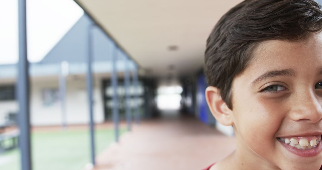 Smiling Schoolboy in Corridor with Copy Space