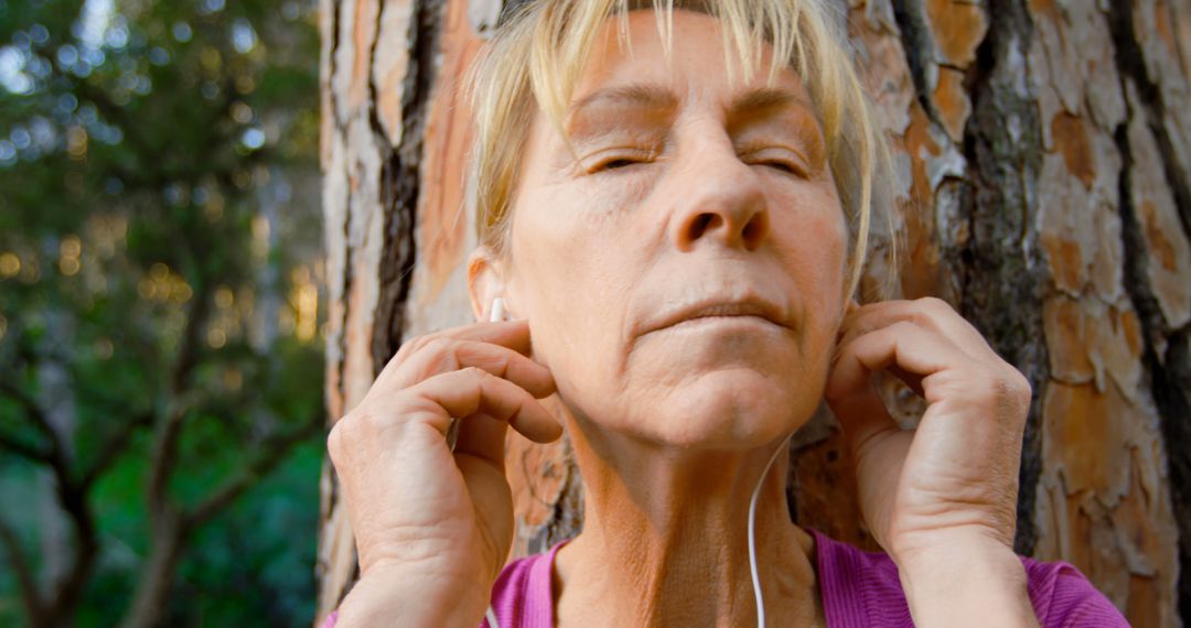 Serene Senior Woman Enjoying Nature with Headphones - Free Images, Stock Photos and Pictures on Pikwizard.com