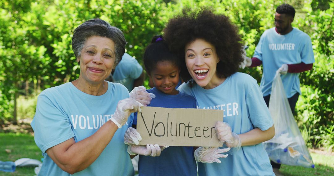 Smiling biracial mother, son and grandmother holding volunteer sign, clearing up trash outdoors - Free Images, Stock Photos and Pictures on Pikwizard.com