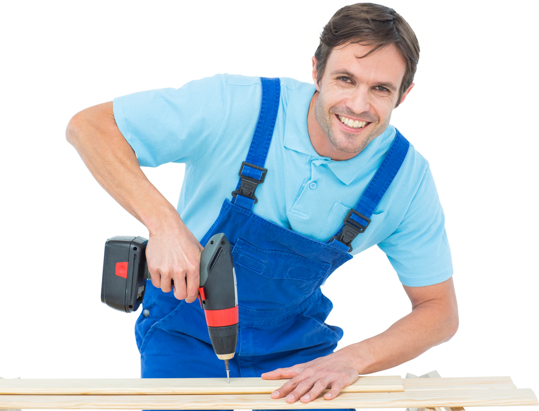 Smiling Male Carpenter Wearing Blue Overalls Using a Drill on Transparent Background - Download Free Stock Images Pikwizard.com