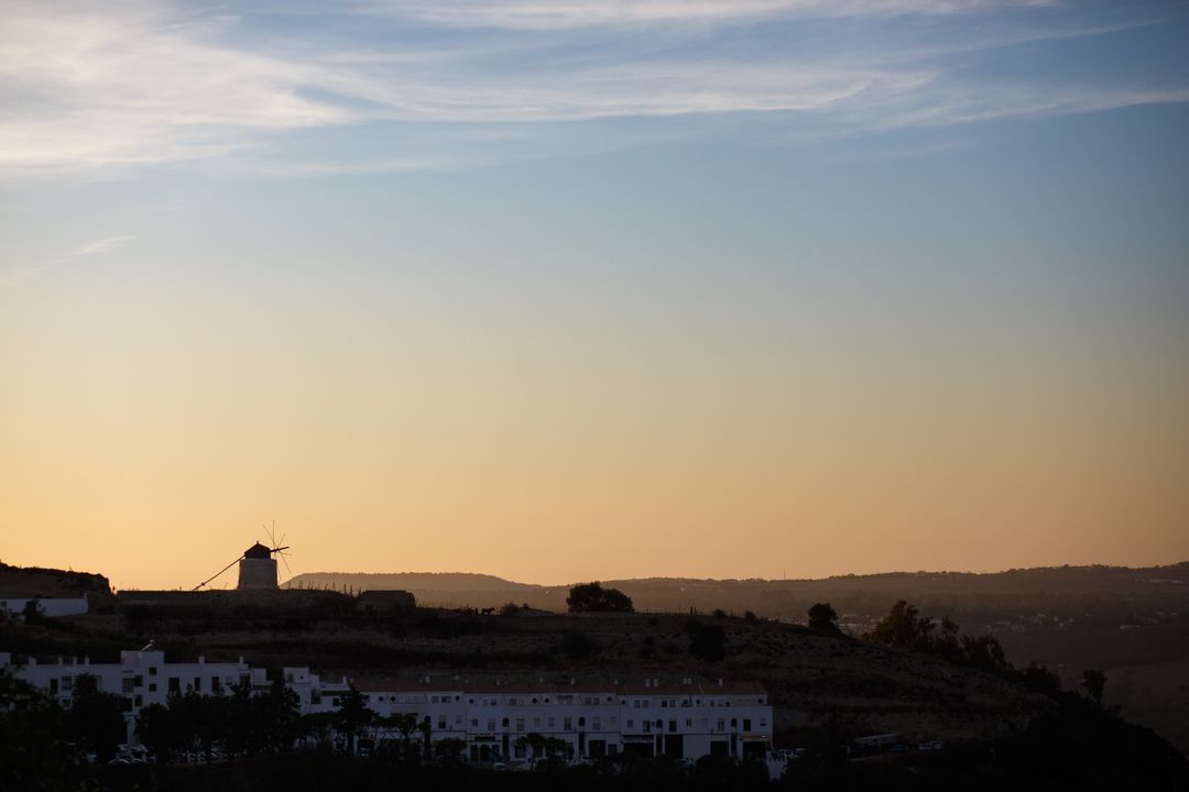 Scenic Sunlit Windmill on Hilltop at Dusk - Free Images, Stock Photos and Pictures on Pikwizard.com