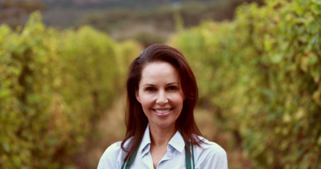 Smiling Woman in Vineyard Wearing Apron - Free Images, Stock Photos and Pictures on Pikwizard.com