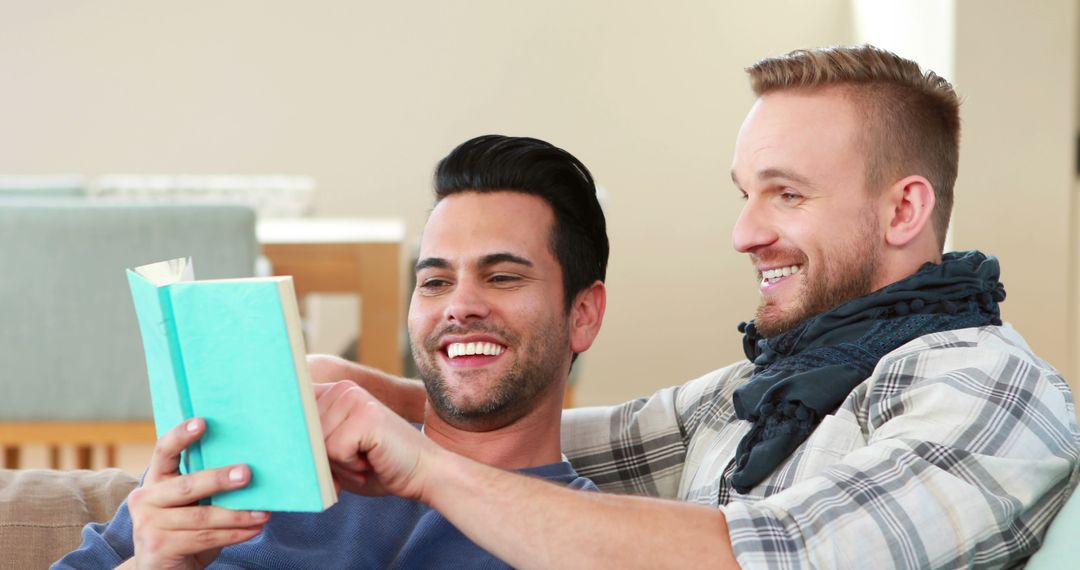 Friends Enjoying a Laugh While Reading Together at Home