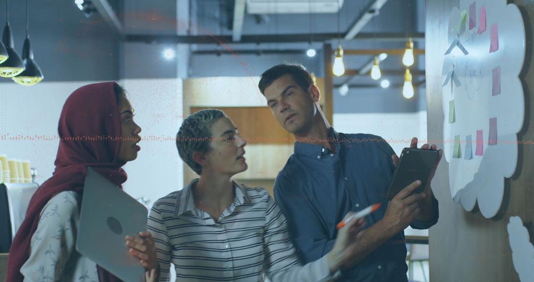 Diverse Business Team Analyzing Financial Data on Whiteboard in Modern Office