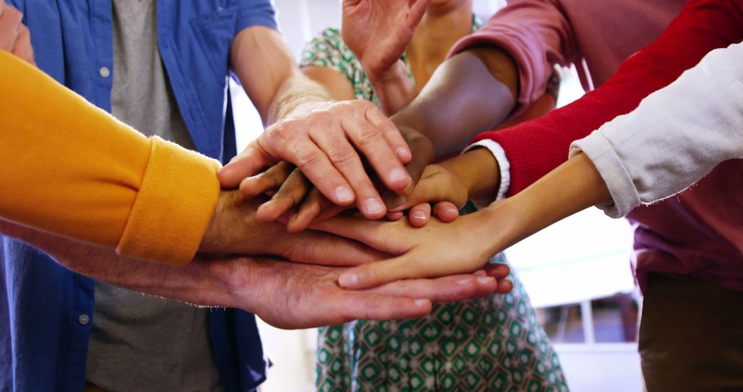 Diverse Group Stacking Hands in Team Unity Gesture - Free Images, Stock Photos and Pictures on Pikwizard.com