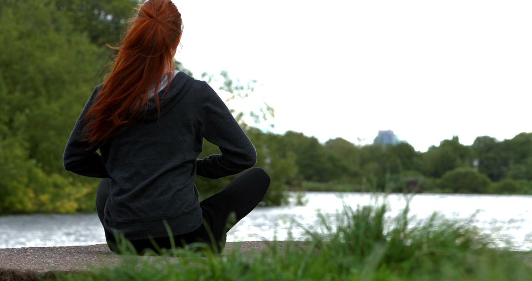 Woman with Red Hair Meditating by Tranquil Lake - Free Images, Stock Photos and Pictures on Pikwizard.com