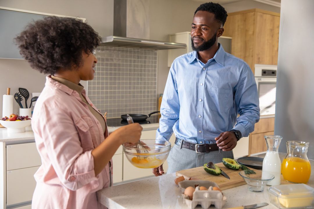 Couple Whisking Eggs Together in Modern Kitchen Setting