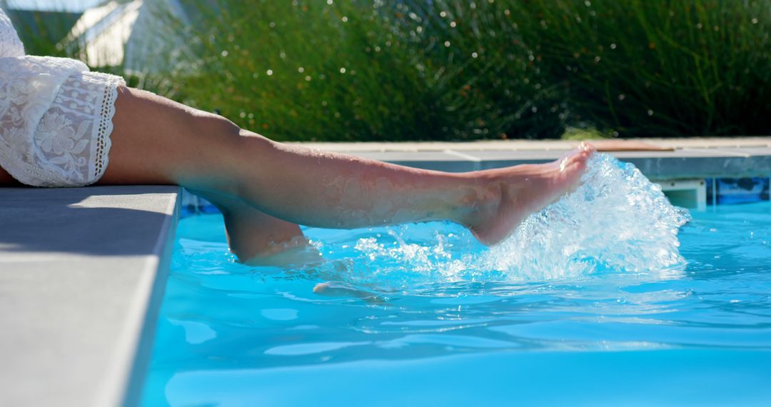 Woman's Legs Splashing Water in Swimming Pool on a Sunny Day - Free Images, Stock Photos and Pictures on Pikwizard.com