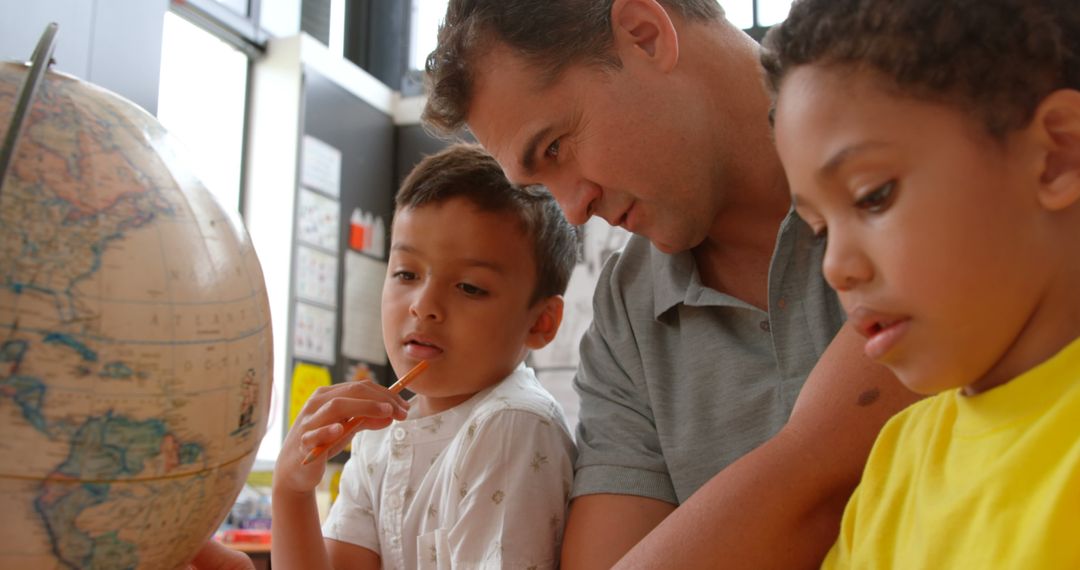 Engaged Teacher Demonstrating Geography with Globe to Diverse Students