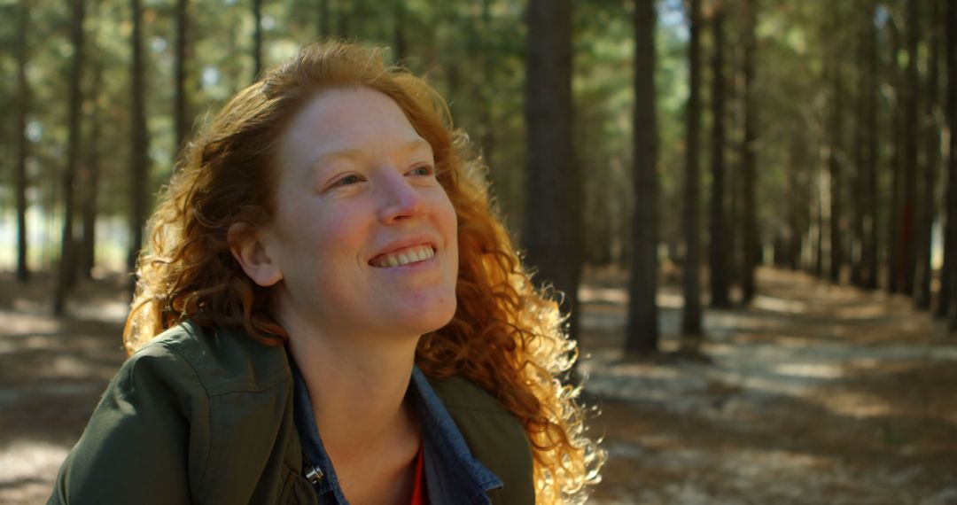 Happy Woman with Red Hair Enjoying Nature in Forest - Free Images, Stock Photos and Pictures on Pikwizard.com