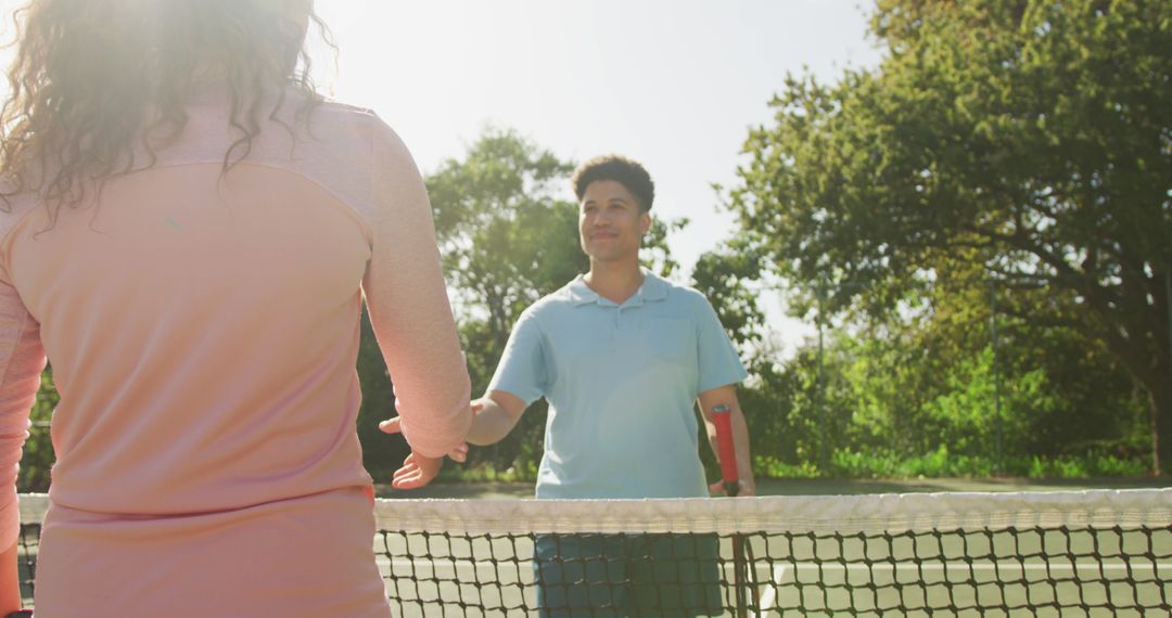 Tennis Match Ending with Handshake Under Bright Sunlight - Free Images, Stock Photos and Pictures on Pikwizard.com