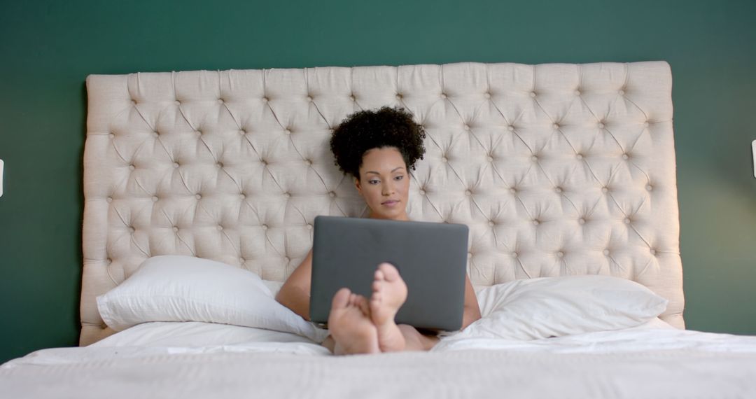 Woman Relaxing in Bed While Working on Laptop - Free Images, Stock Photos and Pictures on Pikwizard.com