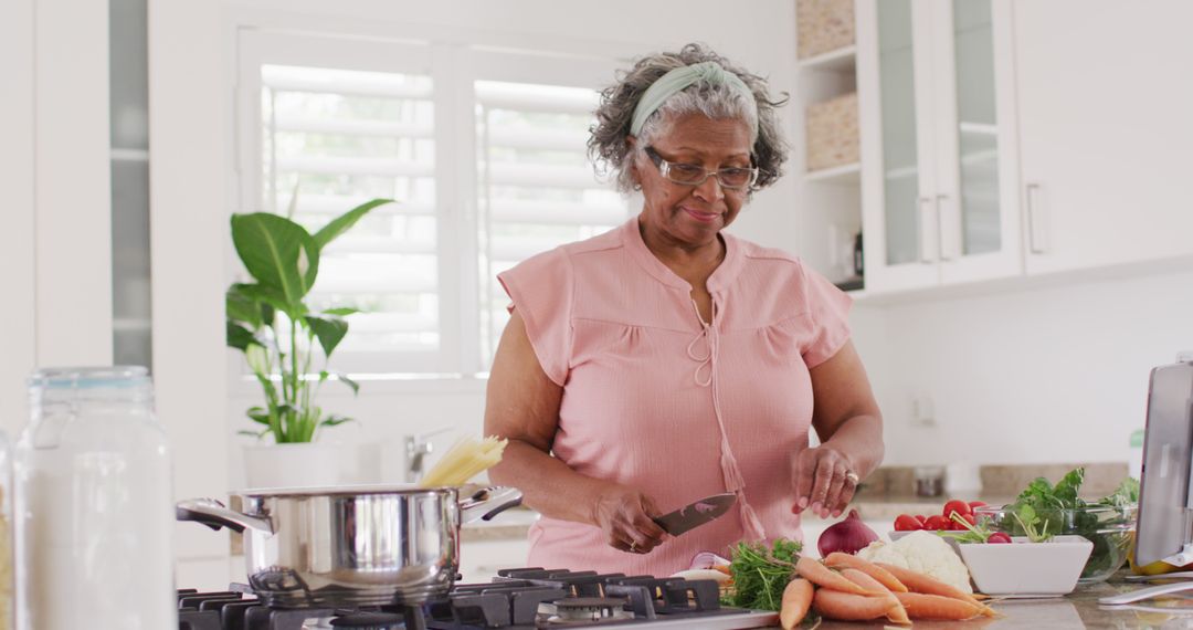 Senior Woman Enjoying Healthy Cooking Lifestyle at Home - Free Images, Stock Photos and Pictures on Pikwizard.com