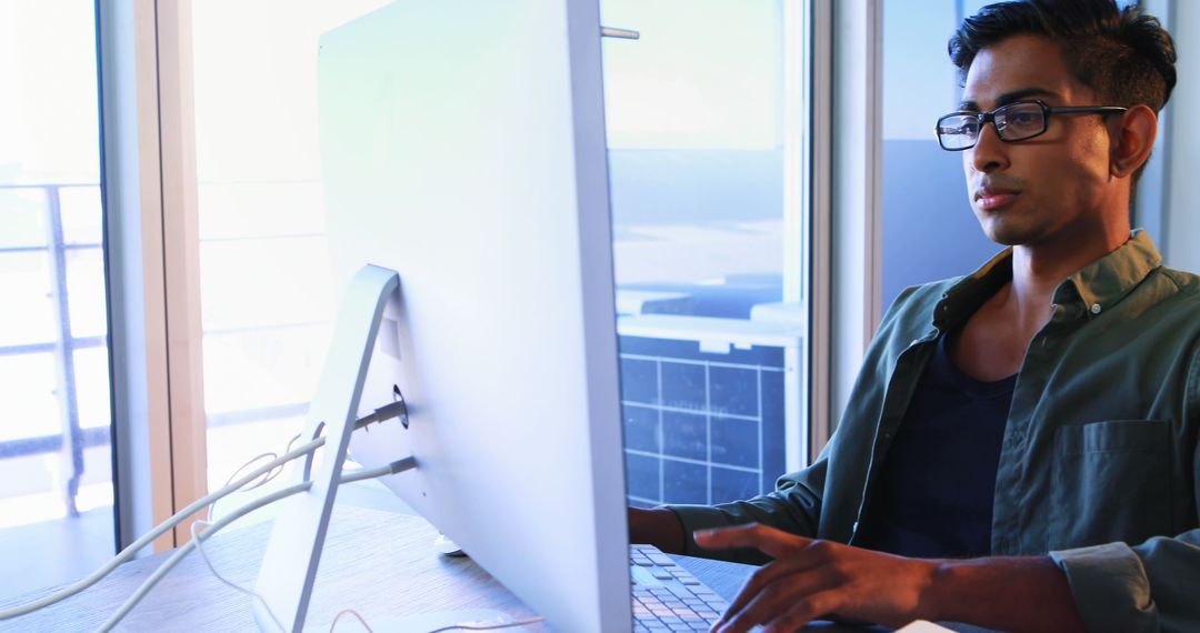 Focused Executive Working on Desktop Computer in Modern Office