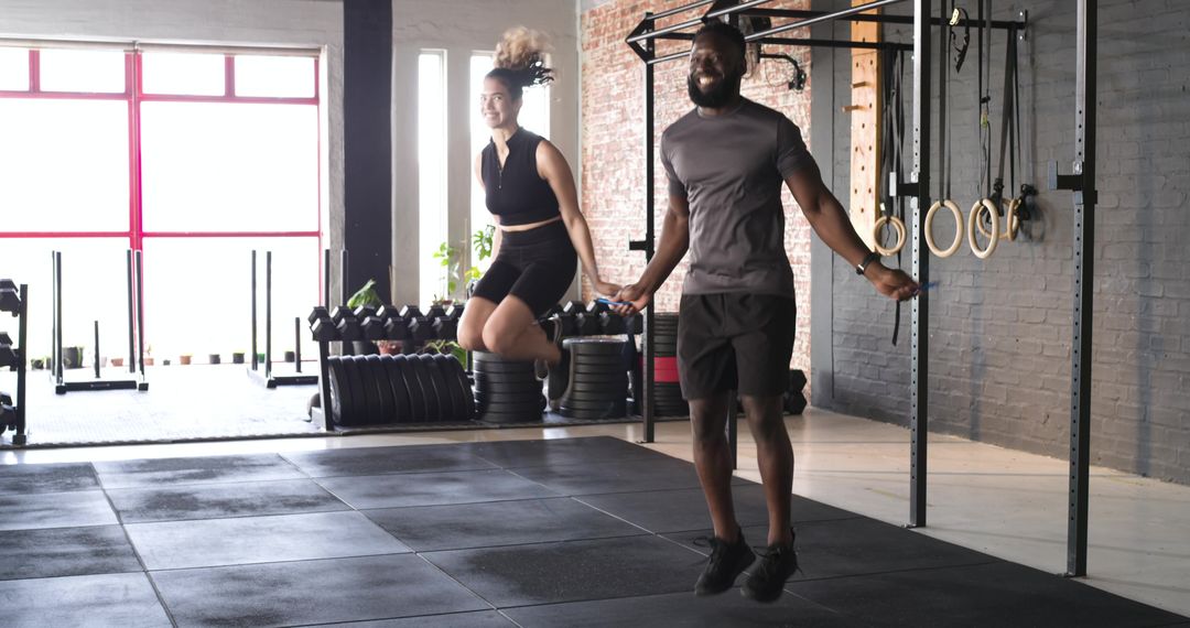 Dynamic Workout Partners Jumping Rope in Modern Gym Setting