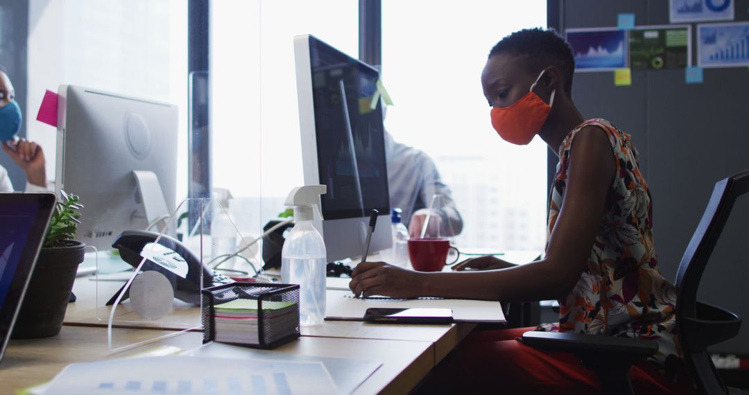 Woman in Mask Working in Modern Office During Pandemic - Free Images, Stock Photos and Pictures on Pikwizard.com