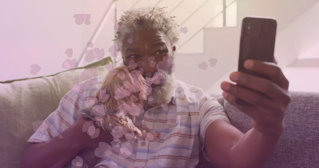 Senior Man with Smartphone and Dog Surrounded by Heart Overlay
