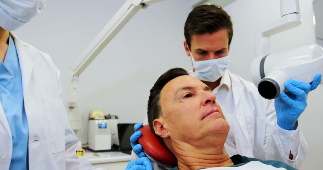 Middle-Aged Man Receiving Dental Examination in Clinic - Free Images, Stock Photos and Pictures on Pikwizard.com