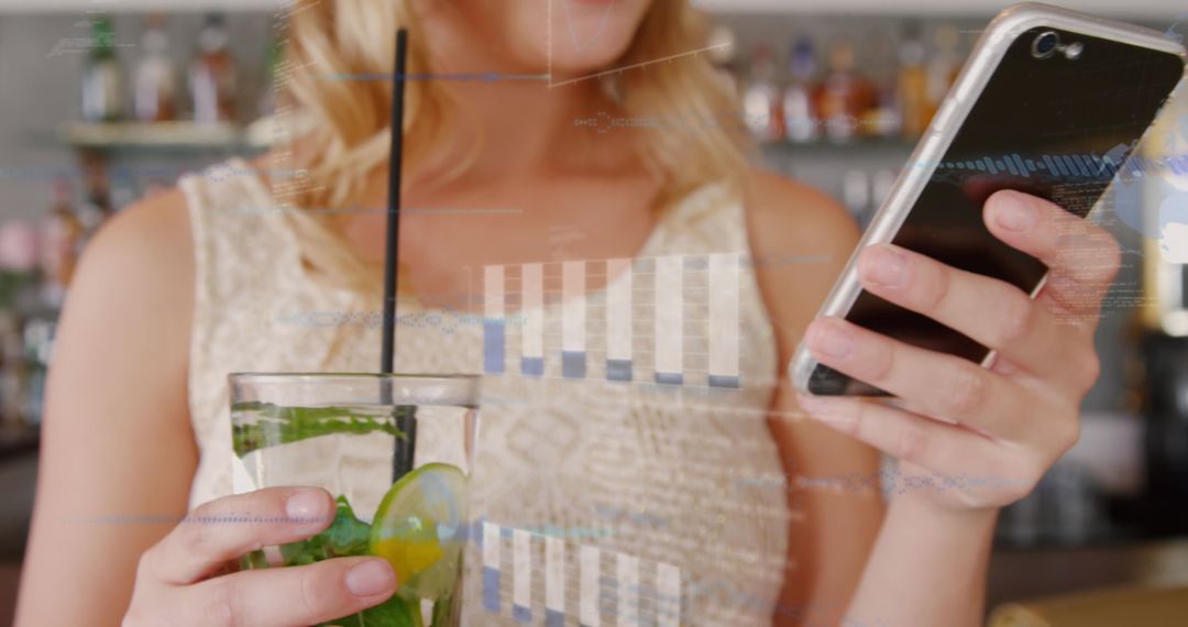 Woman Analyzing Financial Data on Smartphone with Refreshing Drink