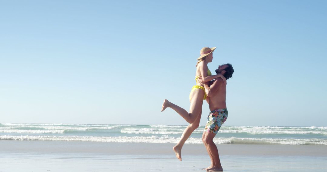 Joyful couple having fun at beach on a sunny day - Free Images, Stock Photos and Pictures on Pikwizard.com