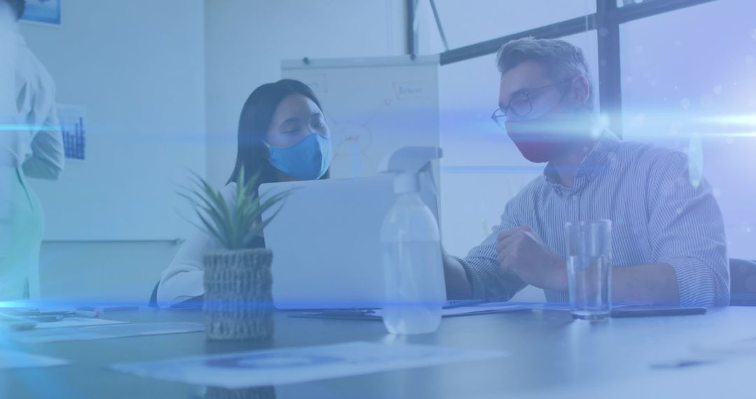 Masked Business Colleagues Discussing in Modern Office with Light Effects