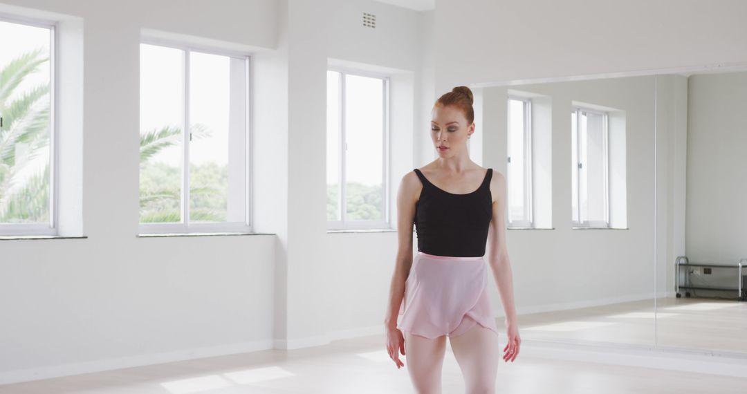 Ballet dancer practicing in bright dance studio with large windows - Free Images, Stock Photos and Pictures on Pikwizard.com