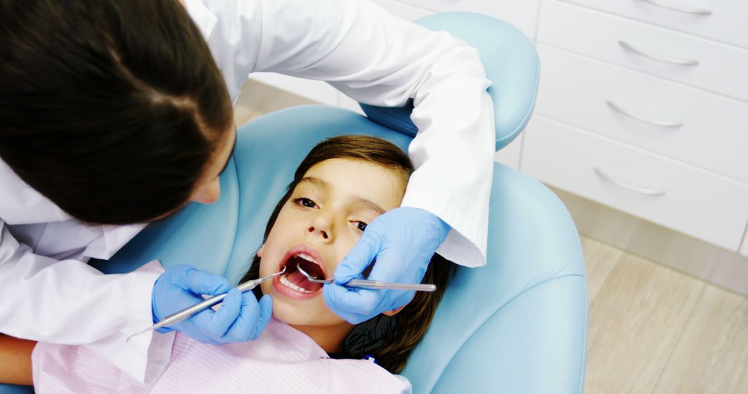 Young Girl Receiving Dental Check-Up by Female Dentist - Free Images, Stock Photos and Pictures on Pikwizard.com