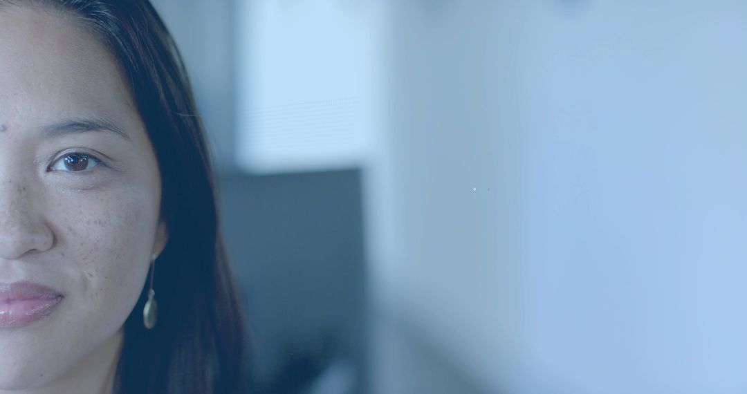 Confident Woman Gazing Forward in Modern Office Space