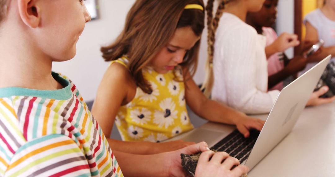 Children Engaged in Active Learning with Laptop in Classroom
