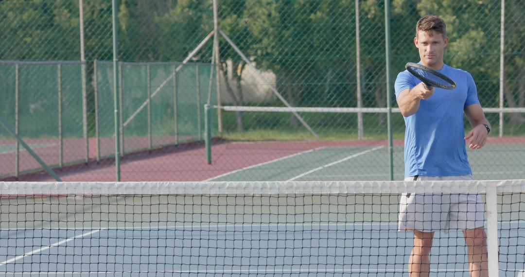 Young Man Practicing Tennis on Outdoor Court on Sunny Day - Free Images, Stock Photos and Pictures on Pikwizard.com