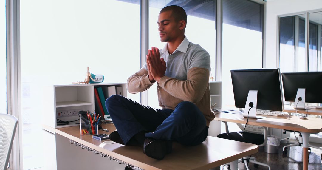 Man Meditating on Office Desk, Finding Calm in Workplace - Free Images, Stock Photos and Pictures on Pikwizard.com