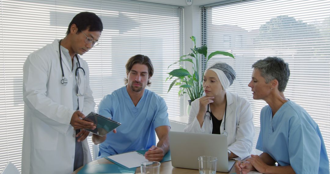 Diverse Medical Team Discussing Patient Care in Modern Office
