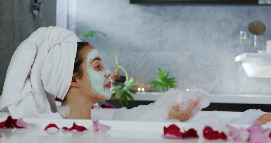 Woman Relaxing in Bathtub with Face Mask and Petals - Free Images, Stock Photos and Pictures on Pikwizard.com