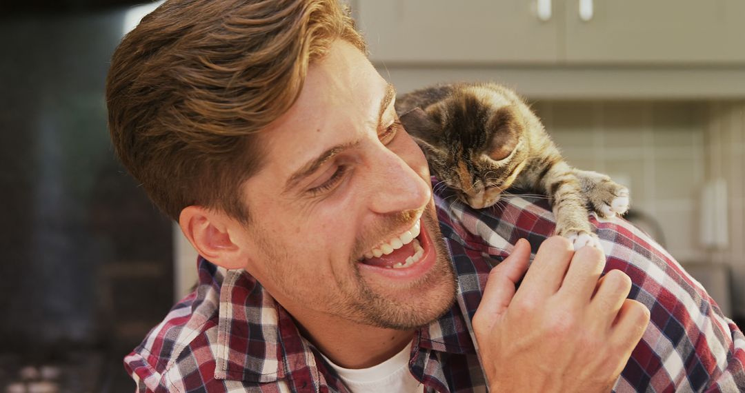 Caucasian Man Smiling with Kitten on Shoulder