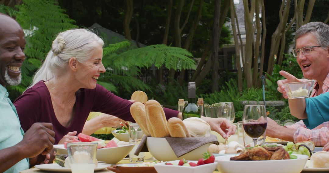 Joyful Seniors Enjoying Outdoor Lunch in Garden - Free Images, Stock Photos and Pictures on Pikwizard.com