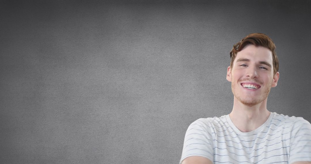Happy Young Man Laughing with Gray Background Portrait