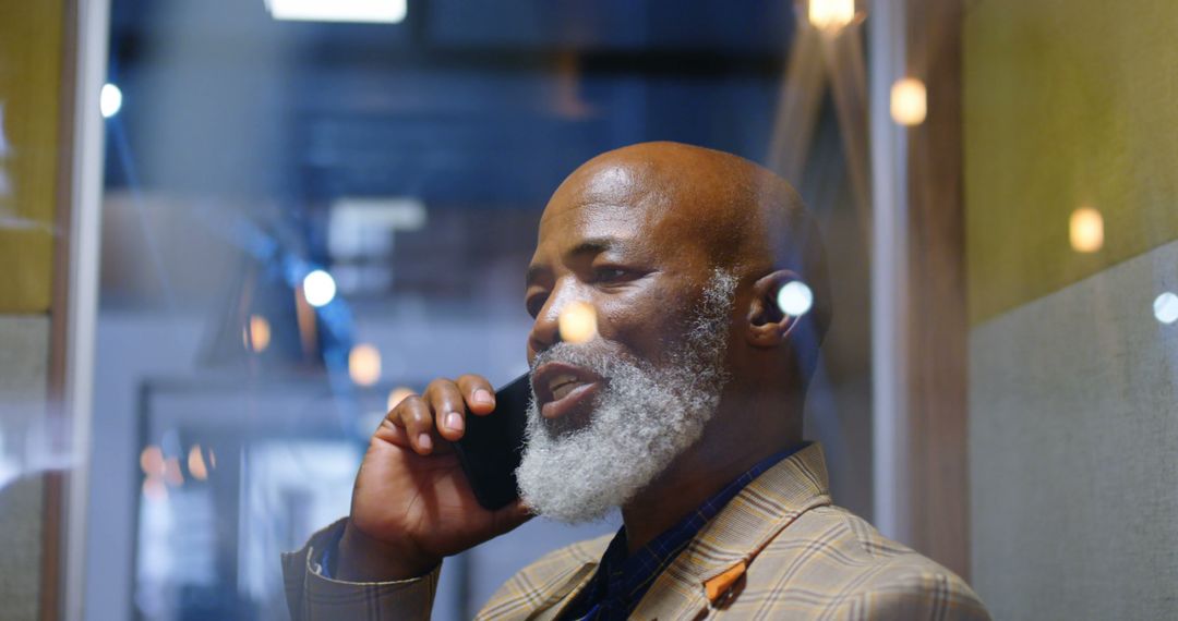 Businessman Engaged in Phone Call in Modern Office Setting