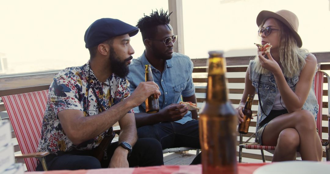 Diverse Friends Enjoying Rooftop Party with Drinks and Pizza