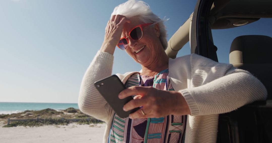 Senior Woman Enjoying Beach Vacation While Using Smartphone - Free Images, Stock Photos and Pictures on Pikwizard.com