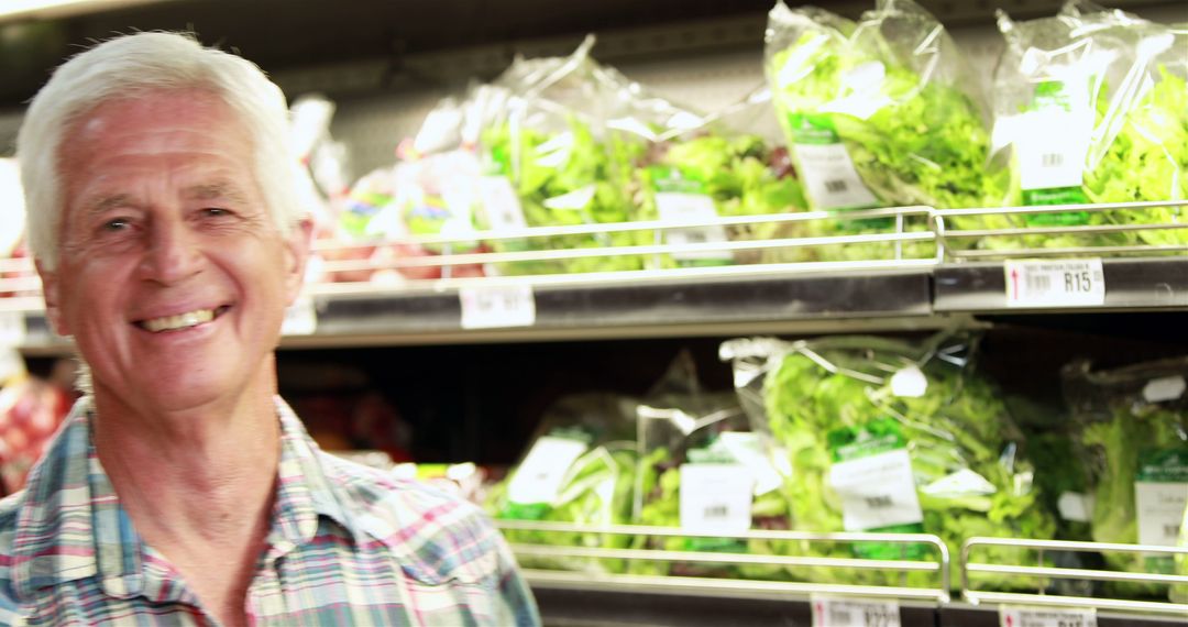 Senior man grocery shopping in vegetable aisle - Free Images, Stock Photos and Pictures on Pikwizard.com