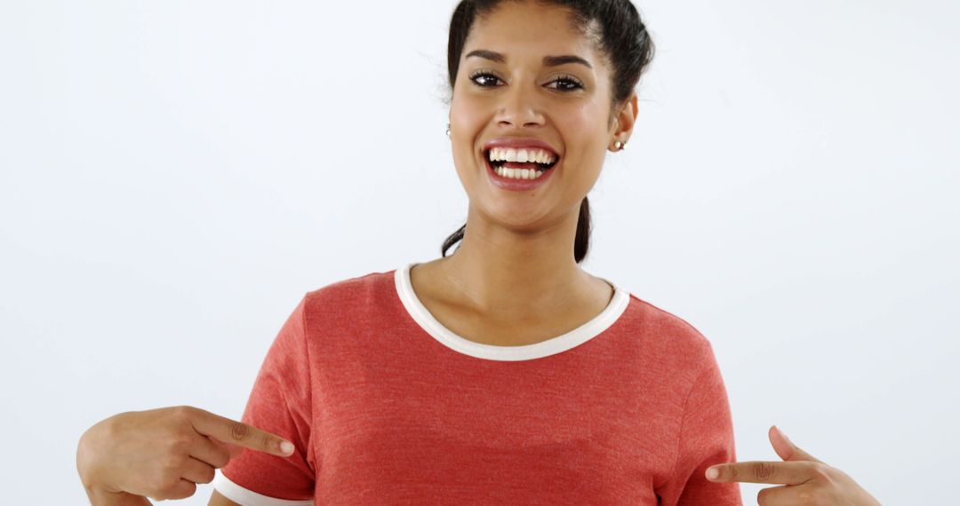 Smiling Woman Pointing at Blank Red T-Shirt - Free Images, Stock Photos and Pictures on Pikwizard.com