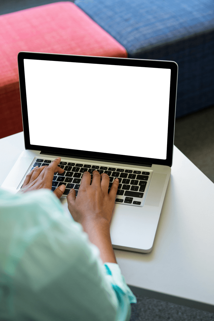 Person Typing on Laptop at Minimalist Office Table in Daylight