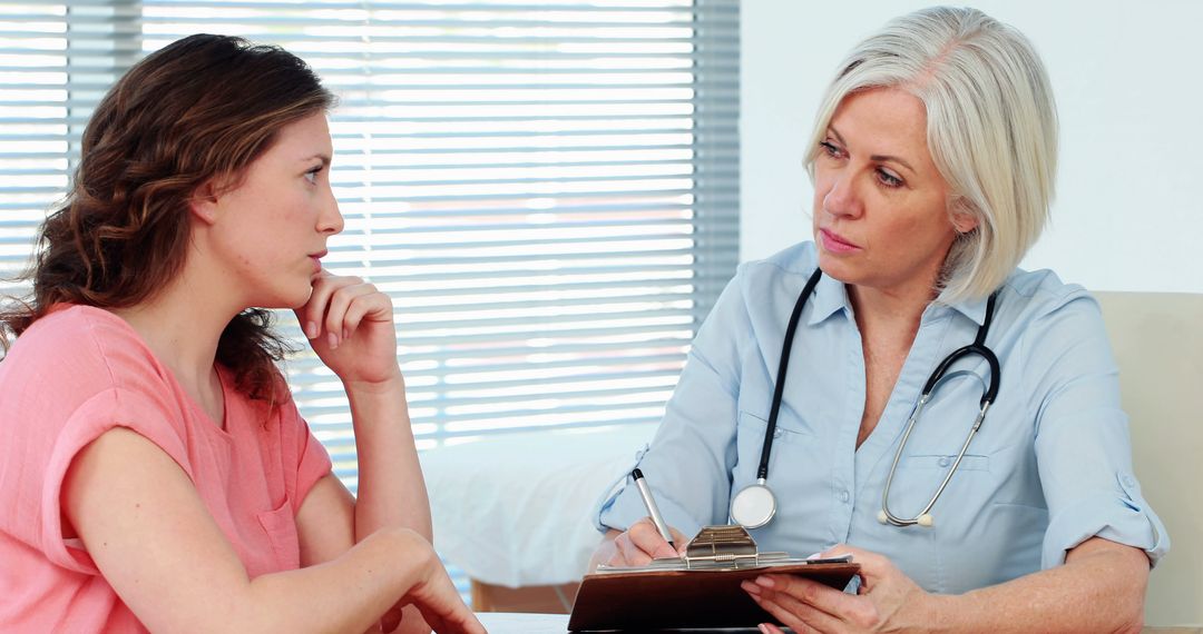 Doctor Consults Young Female Patient in Bright Office - Free Images, Stock Photos and Pictures on Pikwizard.com