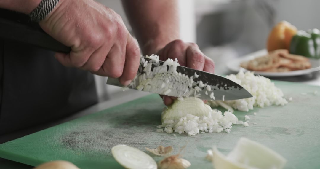 Close-Up of Chef Dicing Onion on Cutting Board in Professional Kitchen - Free Images, Stock Photos and Pictures on Pikwizard.com