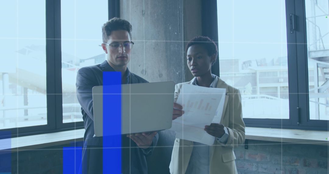 Diverse Business Team Analyzing Financial Data with Laptop