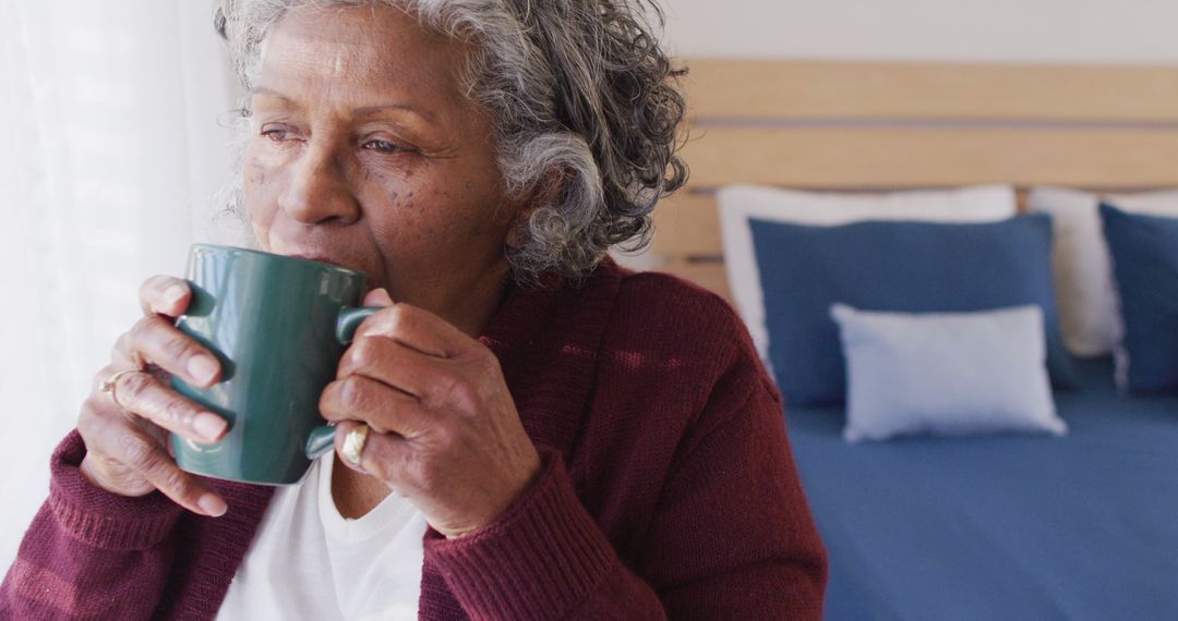 Elderly Woman Drinking Coffee in Cozy Bedroom - Free Images, Stock Photos and Pictures on Pikwizard.com