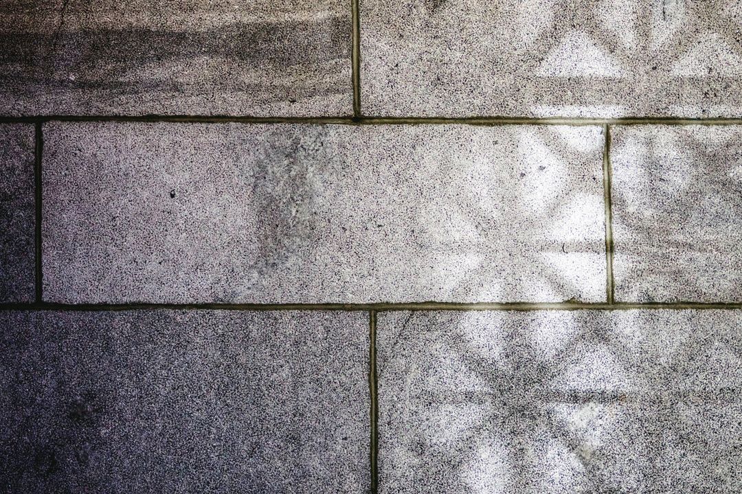 Shadowed Stone Wall with Geometric Patterns