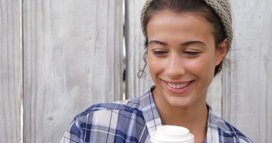 Woman Smiling with Coffee in Casual Urban Setting - Free Images, Stock Photos and Pictures on Pikwizard.com