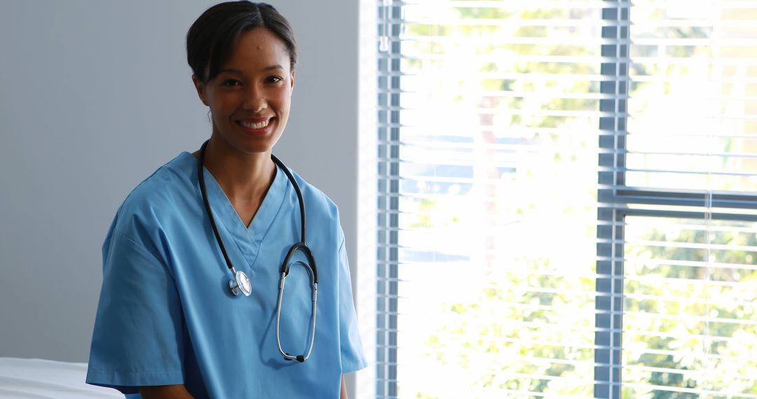 Smiling Female Nurse with Stethoscope in Bright Hospital Room - Free Images, Stock Photos and Pictures on Pikwizard.com