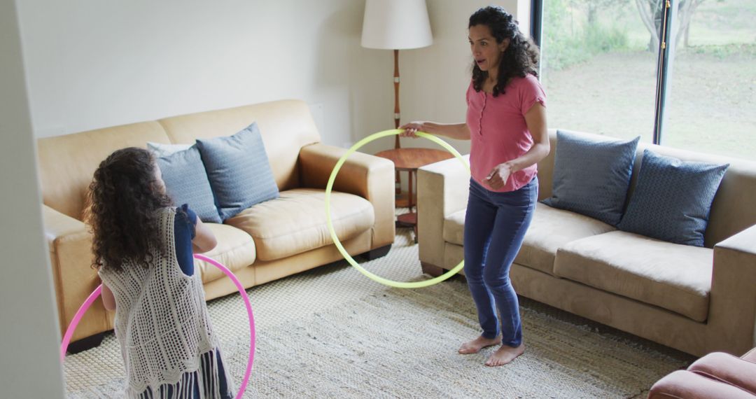 Mother and Daughter Enjoying Hula Hoop Activity Indoors - Free Images, Stock Photos and Pictures on Pikwizard.com